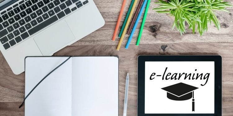 table avec un laptot , cahier et e-learning